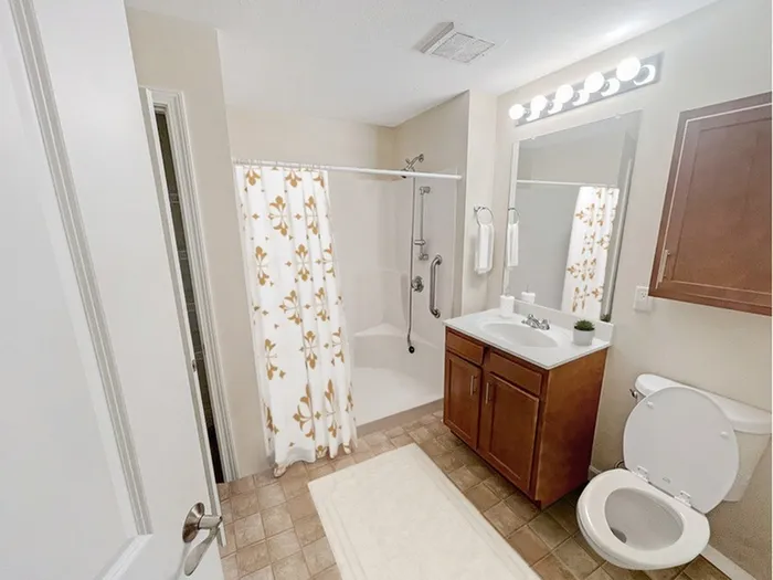 Spacious apartment bathroom with vanity and tub shower at Allard’s Grove in Dracut, MA