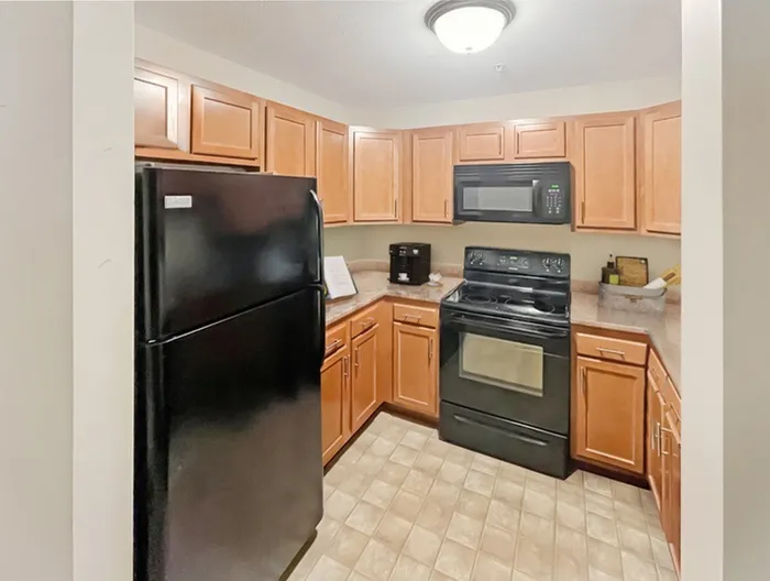 Cozy and functional apartment kitchen with modern appliances at Allard’s Grove in Dracut, MA