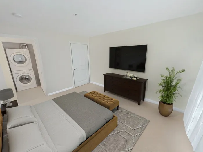 Spacious apartment bedroom with in-unit washer and dryer at Allard’s Grove in Dracut, MA