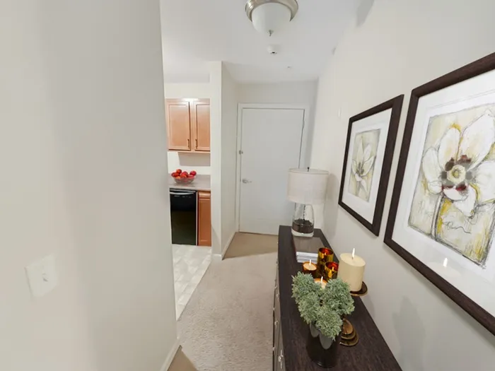 Welcoming apartment entry hallway leading to kitchen and living space at Allard’s Grove in Dracut, MA