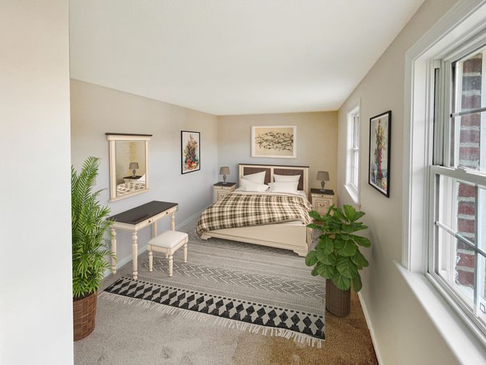 Bedroom with large windows, carpeted flooring, and ample natural light at Meadowbrook Village in Gardner, Massachusetts