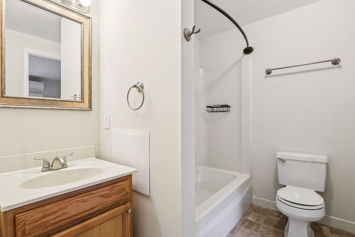 Meadowbrook Village bathroom showing the sink vanity, toilet, and bathtub with shower.
