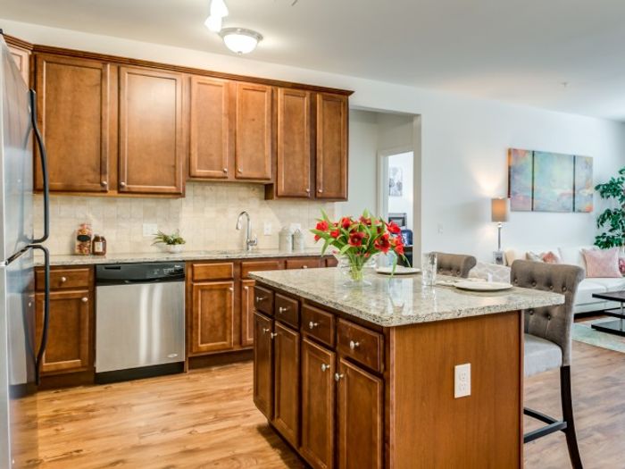 Dog-Friendly Garden Style Apartments in Mt. Laurel Township NJ - Laurel Green - Modern Kitchen wtih Maple Cabinetry, Stainless Steel Appliances, Granite Countertops, Cooking Island with Chairs, and Tile Backsplash