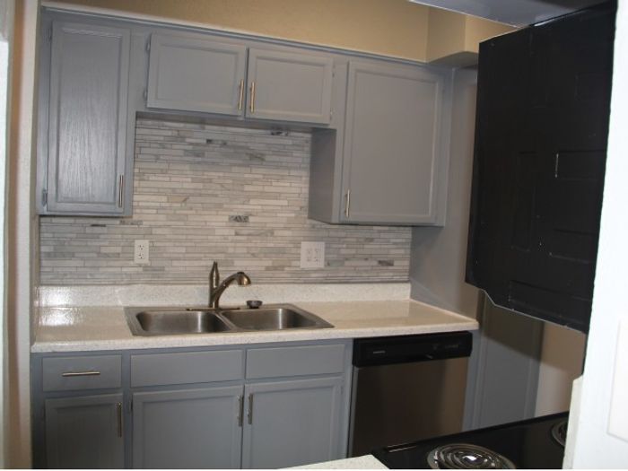 Backsplash, upgraded cabinets and faux hardwood flooring