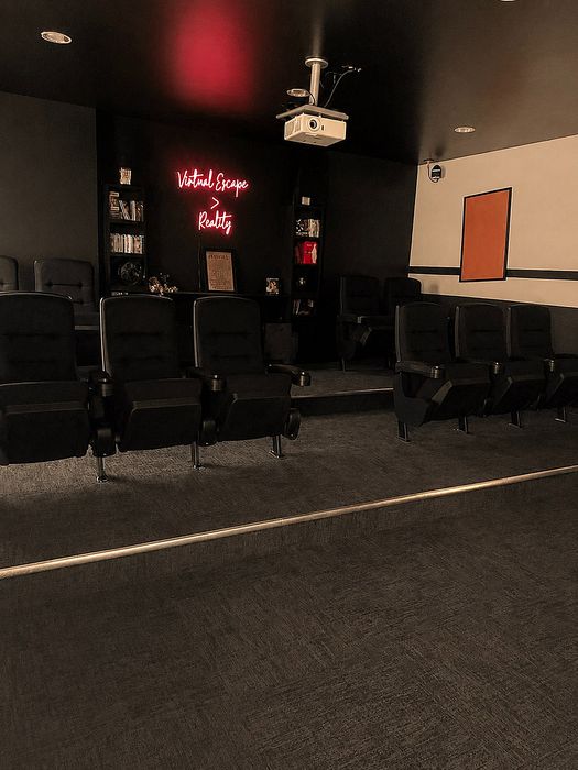 Chic home theater with comfortable seating, ambient lighting, and a neon sign creating a cinematic escape.