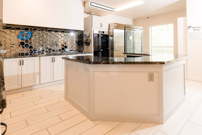 Elegant modern kitchen featuring a sleek hexagonal backsplash, marble countertops, and stainless steel appliances.
