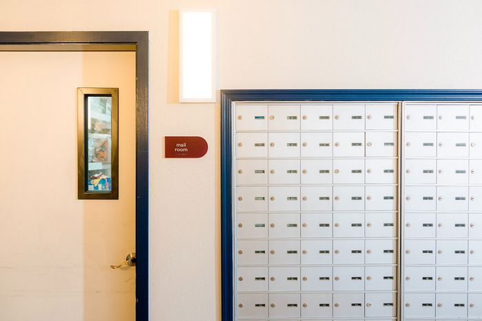 Modern apartment mail room with sleek mailboxes and stylish door design.