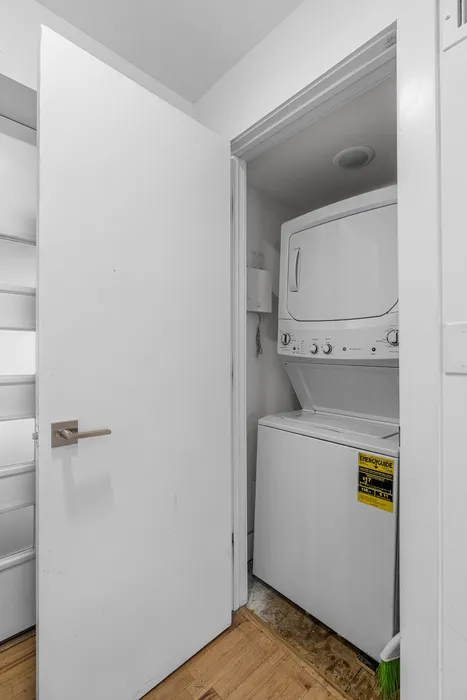 Compact in-unit laundry setup with stackable washer and dryer offering convenience.
