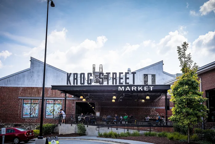 Vibrant Krog Street Market entrance showcasing its bustling atmosphere and historic brick facade, perfect for dining and shopping.