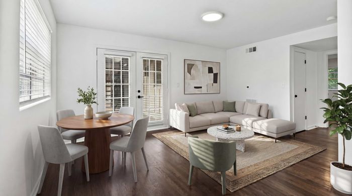 Bright and inviting living space with a cozy sectional sofa, elegant dining area, and modern decor, bathed in natural light.