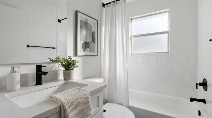 Bright and elegant bathroom featuring sleek fixtures, modern design, and abundant natural light.