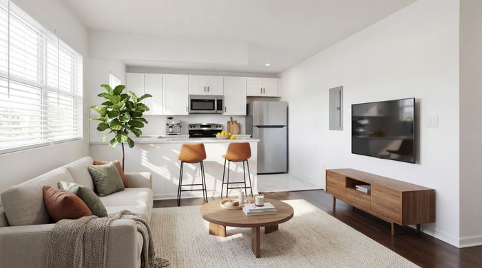 Modern open-concept living space with cozy sofa, stylish kitchen with breakfast bar, and sleek decor.