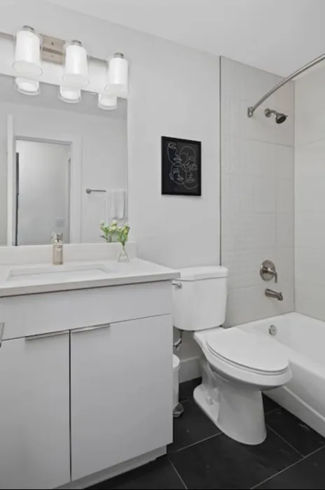 Modern bathroom design featuring sleek white fixtures, elegant vanity, and contemporary lighting for a bright and inviting space.