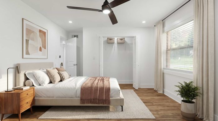 Elegant bedroom with modern decor, featuring a cozy bed, stylish wooden nightstand, and ample natural light from large windows.