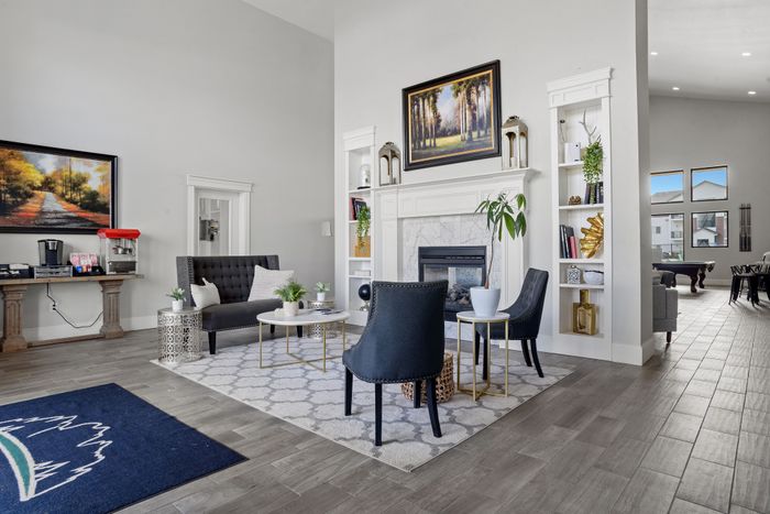 Chic living room with modern decor, cozy fireplace, and stylish seating in an airy open-concept area.