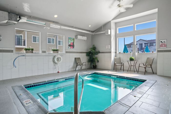 Inviting indoor pool area with natural light, stylish decor, and comfortable seating for a relaxing retreat.