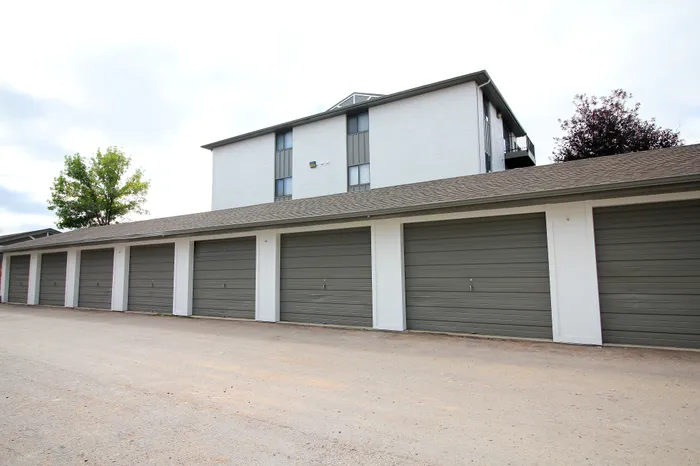 Modern apartment complex with ample garage spaces offering convenience and secure parking.