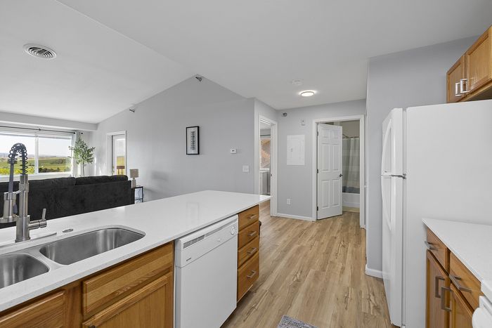 Bright open-plan kitchen and living area with modern appliances and large windows offering scenic countryside views.