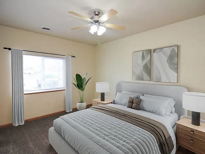 Elegant bedroom with modern decor, cozy bed, stylish lamps, and a large window for natural light.