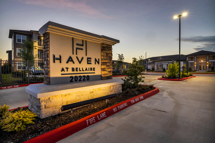 Elegant entrance of Haven at Bellaire, showcasing modern architecture and ambient evening lighting.