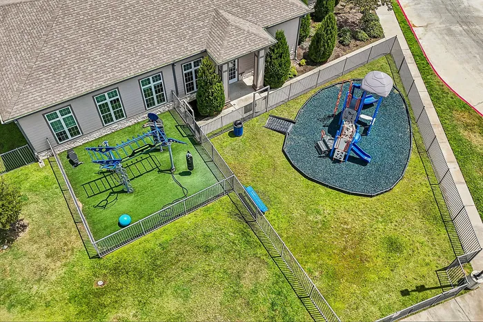 Inviting aerial view of a vibrant apartment playground featuring modern play structures and lush green spaces for family enjoyment.