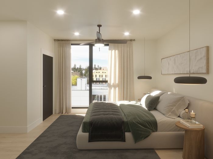 Elegant bedroom featuring a plush bed with cozy linens, modern hanging lights, and a scenic view through large windows.