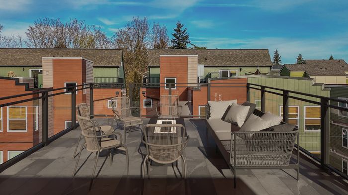 Chic rooftop terrace featuring modern wicker furniture and scenic urban views, perfect for relaxation and entertaining.