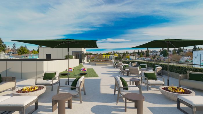 Luxurious rooftop terrace featuring cozy fire pits, elegant seating, and stunning skyline views.