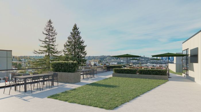 Scenic rooftop patio with lush greenery, modern furniture, and panoramic city views.