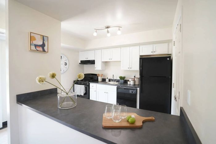 Apartments for Rent in Millersville, PA - Millers Crossing Apartments - Kitchen with Black Appliances, White Cabinets, and Spacious Countertops