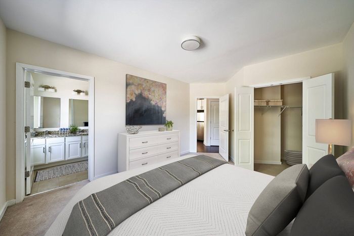 2-BR Apartments in Ardmore PA - The Athens - Furnished Bedroom with a Spacious Closet, Plush Carpeting, and In-Suite Bathroom with Double Vanity Sinks