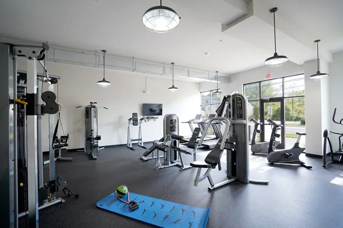 Doyletown PA Apartments - Butler Square - Fitness Center with Weightlifting Equipment, Exercise Machines, Large Windows, and TV
