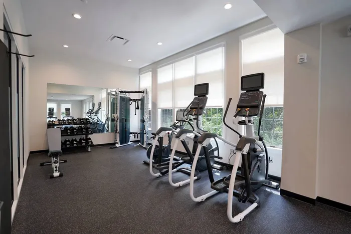 Apartments Near PNC Park - Bear Run Village - State-Of-The-Art Fitness Center With Multiple Cardio, Weight Machines, and Free Weights In Front Of A Large Mirror