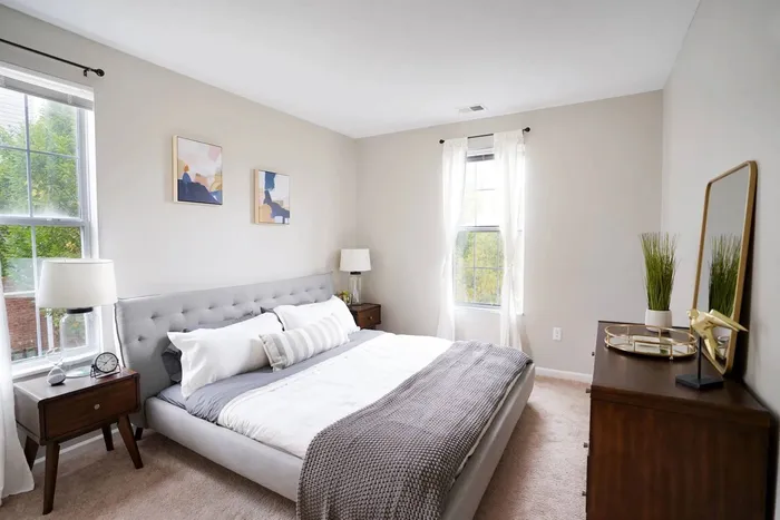 Pet-Friendly Apartments In Pittsburgh PA - Bear Run Village - A Bright And Spacious Bedroom With Plush Carpeting, and Two Windows For Natural Light