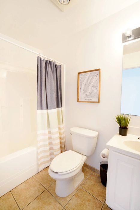York Apartments - Ribbon Place - Kitchen with Wood-Style Flooring, Dark Brown Countertops, Light Brown Cabinets, and Stainless Steel Appliances