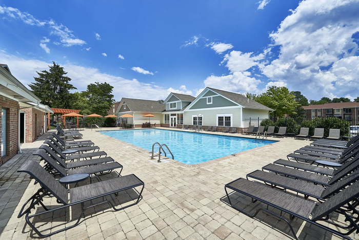 Three-Bedroom Apartments in Frederick, MD - Willowdale Crossing - Pool with Expansive Sundeck, Black Lounge Seats, Umbrella Tables and Chairs.