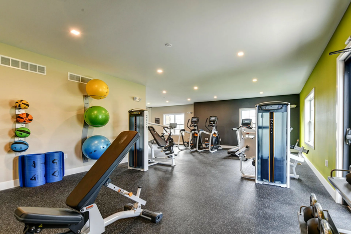 Apartments Near Penn State Harrisburg - Woodland Hills - A Bright And Spacious Fitness Center With Multiple Cardio Machines, Weight Machines, And Free Weight Options