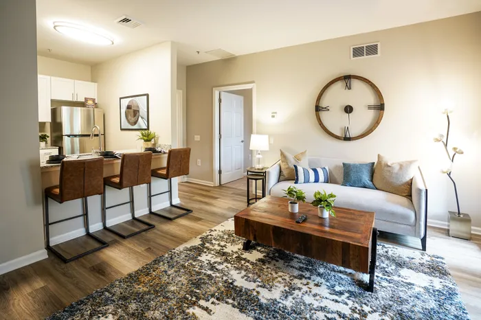 Pet-Friendly Apartments in Plymouth Meeting, PA - Plymouth Pointe - Furnished Living Room with Wood-Style Flooring and View of Kitchen Area