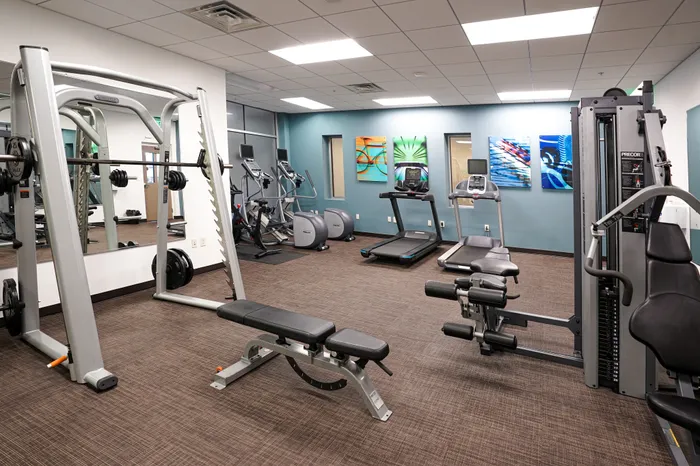 Apartments in West Chester for Rent - Market Street Flats - Fitness Center with Cardio Machines, Free Weights, Strength Training Equipment, and Mirror Wall