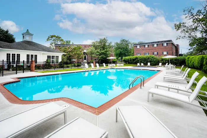 Apartments For Rent In Norristown - Norris Hills - Gated Pool With Lounge Chairs, Chairs, Umbrellas, And Maintained Green Hedges