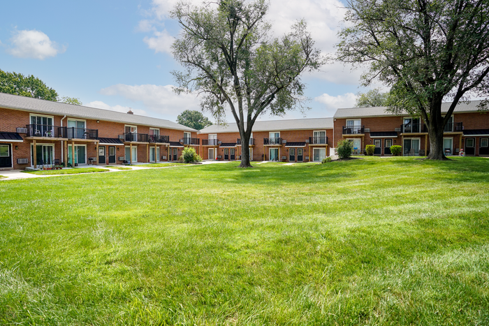 Apartments for Rent in Upper Chichester, PA - Aston Glen - Wide Open Courtyard Between Apartment Buildings with Well-Maintained Grass and Big Trees