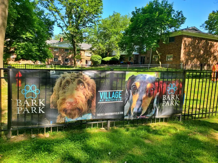 Outdoor dog park at Village at Mayfield in Mayfield, OH, with a spacious lawn.