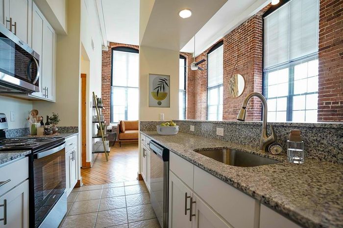 Apartments in Allentown, PA with an In-Unit Washer and Dryer - The Mill - Kitchen with Tiles Flooring, Granite Countertops, and Stainless Steel Appliances