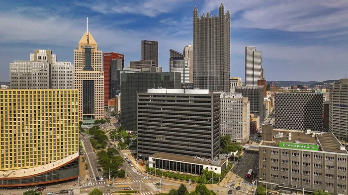 Dog-Friendly Apartments in Pittsburgh, PA - Apartments at River View - Exterior with Skye View, Street Access, and Trees