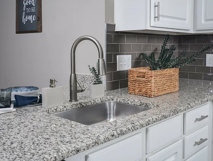 Dog-Friendly Apartments in Plymouth Meeting, PA - Plymouth Pointe - Kitchen with Stainless Steel Appliances, White Cabinets with Grey-Granite Countertops, and Wood-Style Plank Flooring