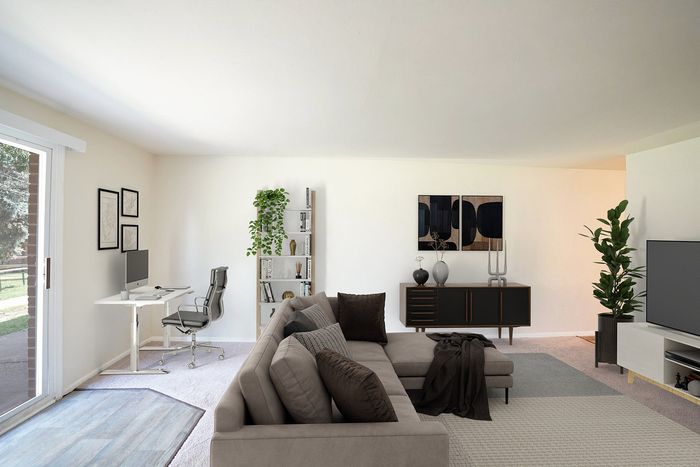 Upper Chichester, PA Apartments for Rent - Aston Glen - Empty Living Room With Plush Carpeting, Light-Colored Walls, and a Sliding Glass Door