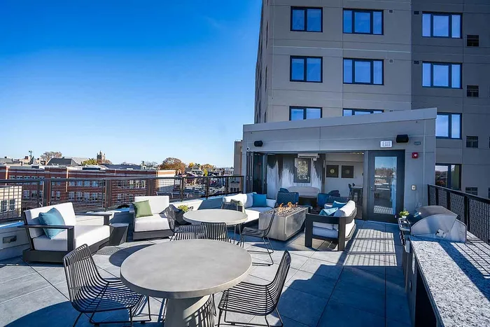 Studios in Lancaster, PA - 202 Queen - Rooftop Deck with Tables and Chairs, Lounge Seats, Firepit, Grill, and City Views.