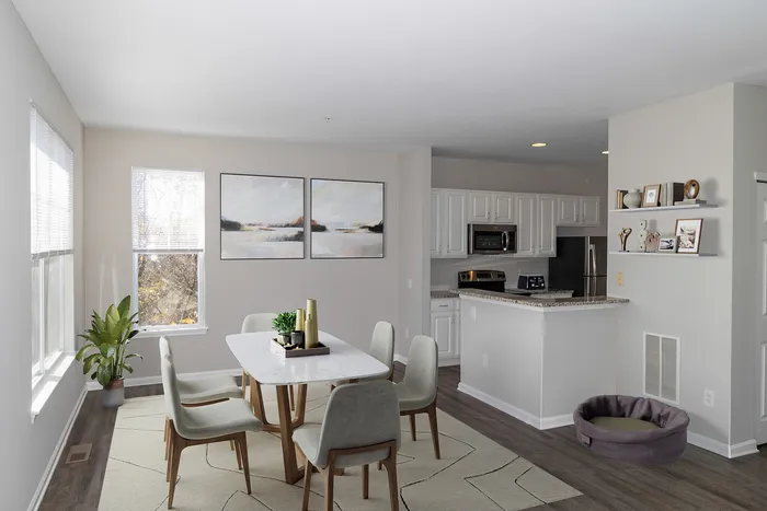 Dog-Friendly Apartments in Plymouth Meeting, PA - Plymouth Pointe - Kitchen with Stainless Steel Appliances, White Cabinets with Grey-Granite Countertops, and Wood-Style Plank Flooring