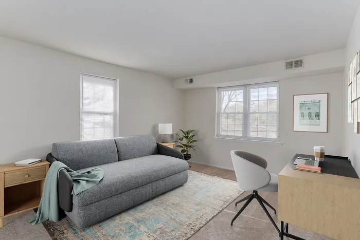 1 BR Apartments in Boothwyn, PA - Willowbrook - Furnished Bedroom with Carpeted Floor, Bed, Wooden Nightstand and Dresser, Windows and Decor.
