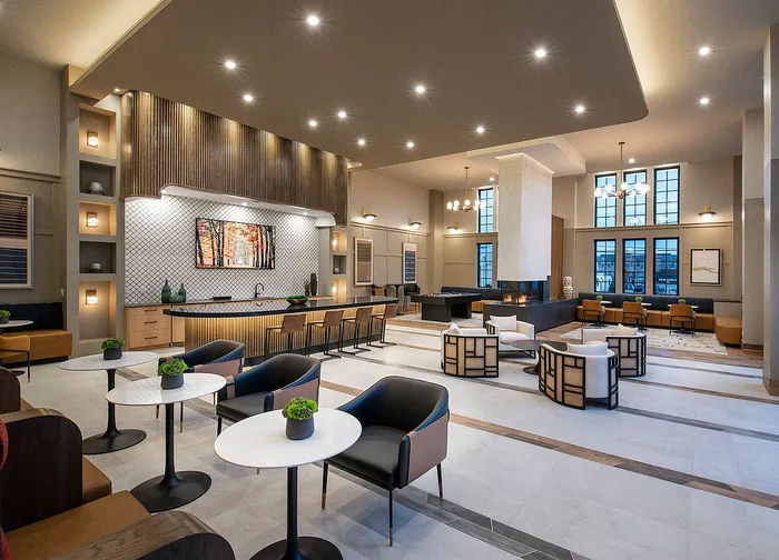 Luxurious modern lounge with stylish seating, ambient lighting, and a sleek fireplace.